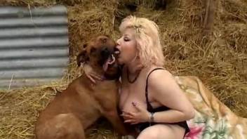 BBW with gigantic tits is fucking with a dog on a hay