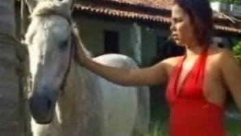 Naked milf is intrigued by the horse's huge penis