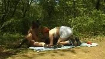 Outdoor fuck scene with two MILFs and their dog