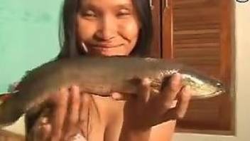 Thai MILF fucking her pussy with a big fish dildo